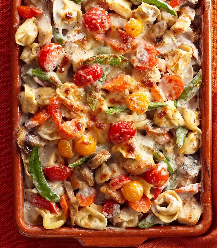 Tortellini and vegetable bake with creamy sauce and melted cheese